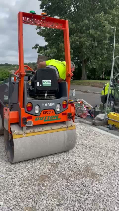 Roller compacting a stone sub-base before surfacing